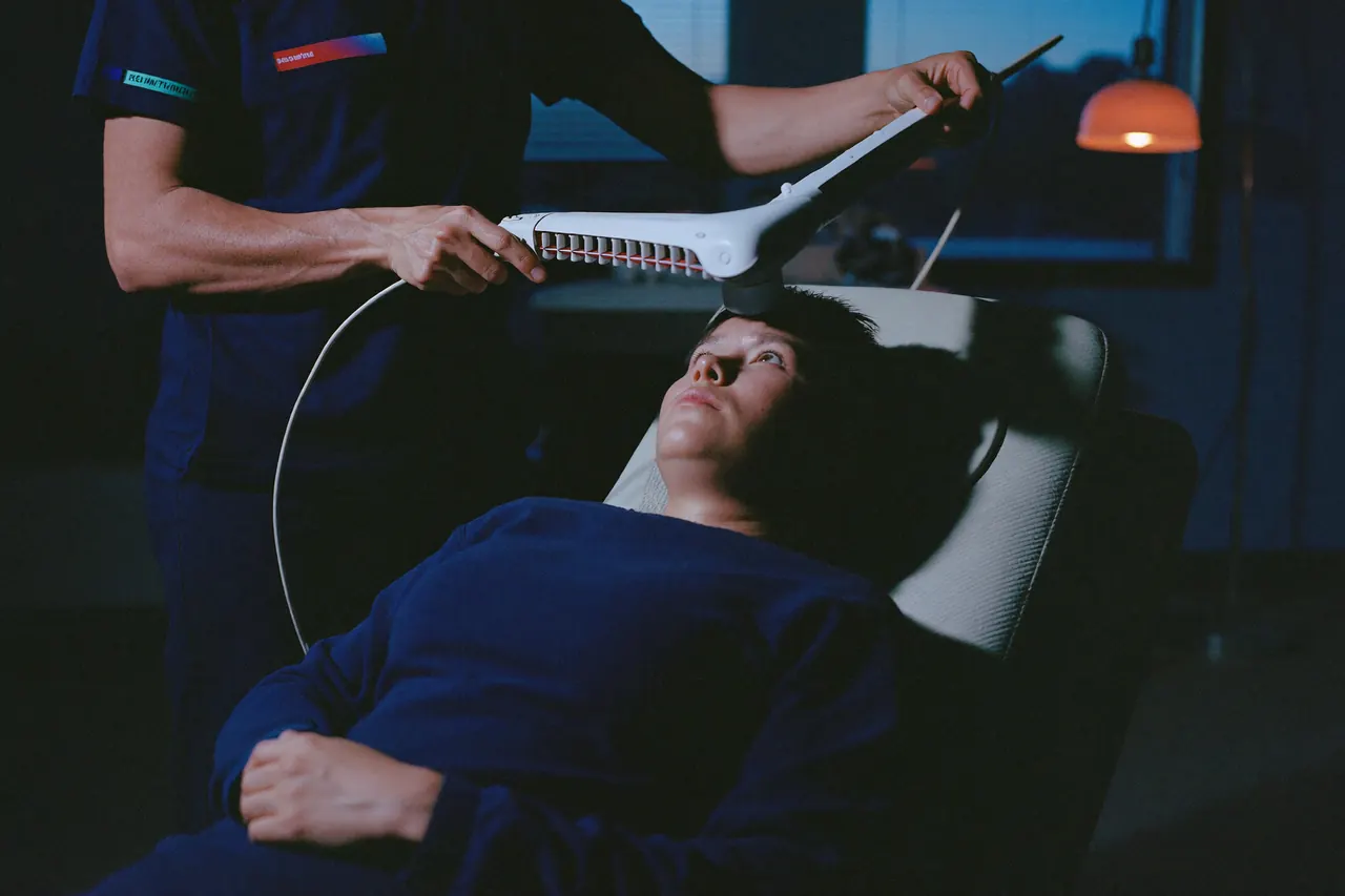 A TMS technician positioning a treatment coil for a patient in a recliner